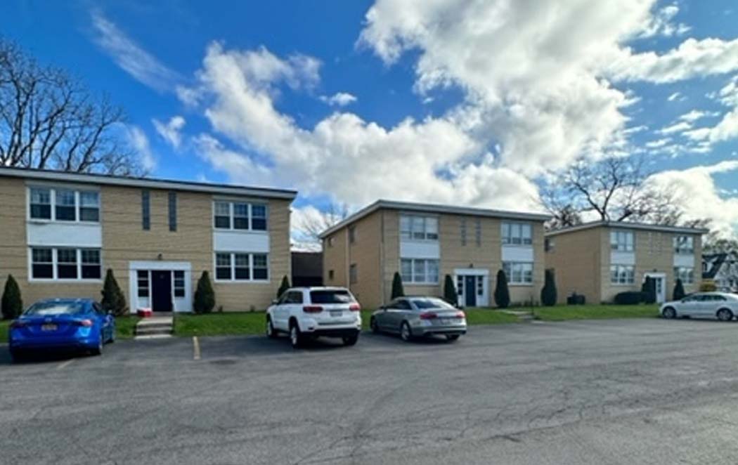 Exterior photo showing two buildings and the parking lot at 30 Linwood in Williamsville, NY